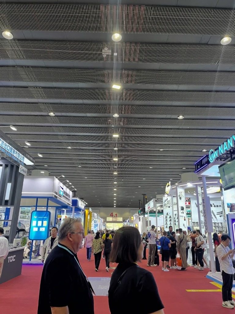 Exhibition hall with red carpet and exhibitor booths